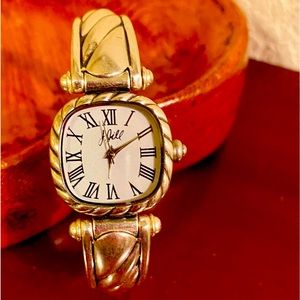 Silver bracelet watch with detailed inlay design. Hinged opening.